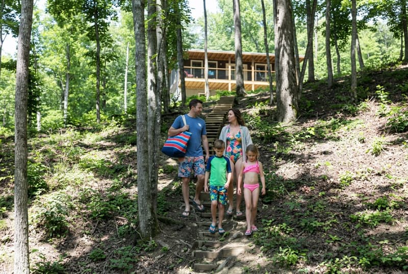 A family walking the path down to the lake