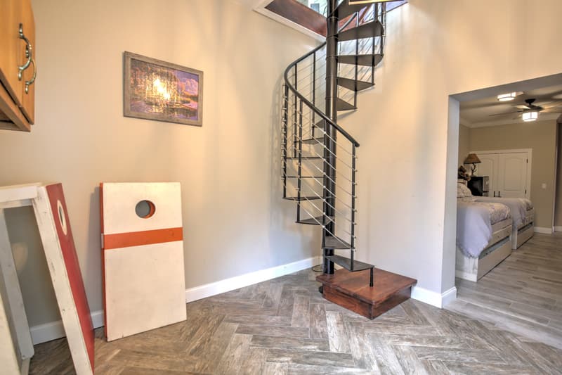 Lower-level entry with spiral stair and cornhole boards