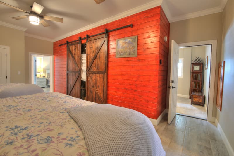 King bedroom with red barn-door wall