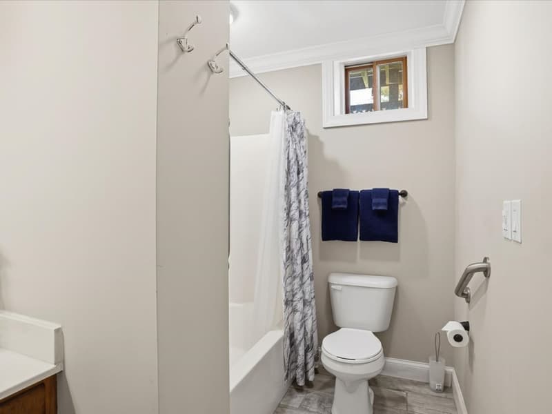 Lower-level bathroom with tub and shower